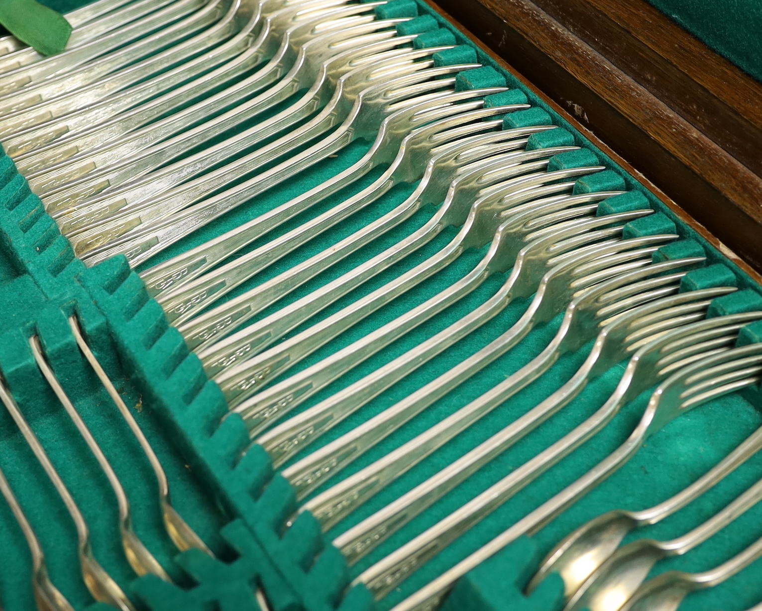 An almost complete George VI Art Deco silver canteen of cutlery by Walker & Hall comprising seventy five items, 119.6oz, together with eleven ivorine handled table knives and twelve dessert knives (two with replaced hand